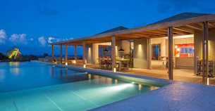 Villa Nina overlooking a moored private boat in the ocean at St Barts.