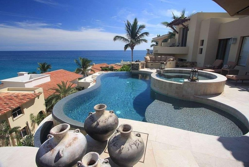 View of the pool, and hot tub overlooking the ocean