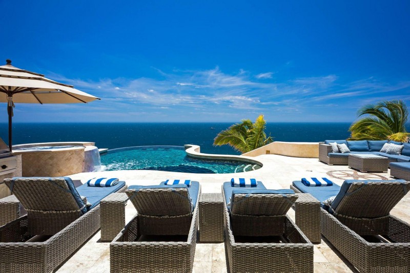 View of the sunbeds and pool overlooking the sea